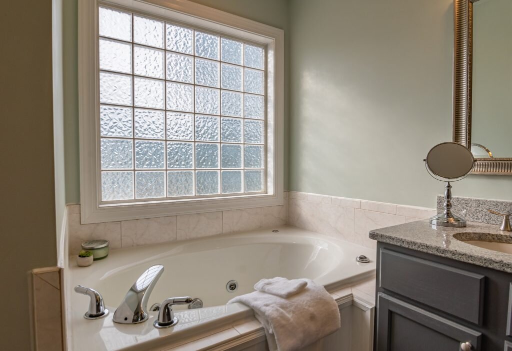 Carefully consider windows and ventilation before adding another bathroom to your new home.