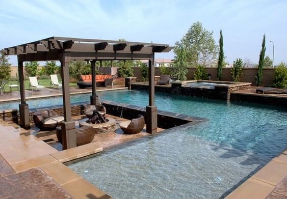 Outdoor fire pit with sitting area in between the pool